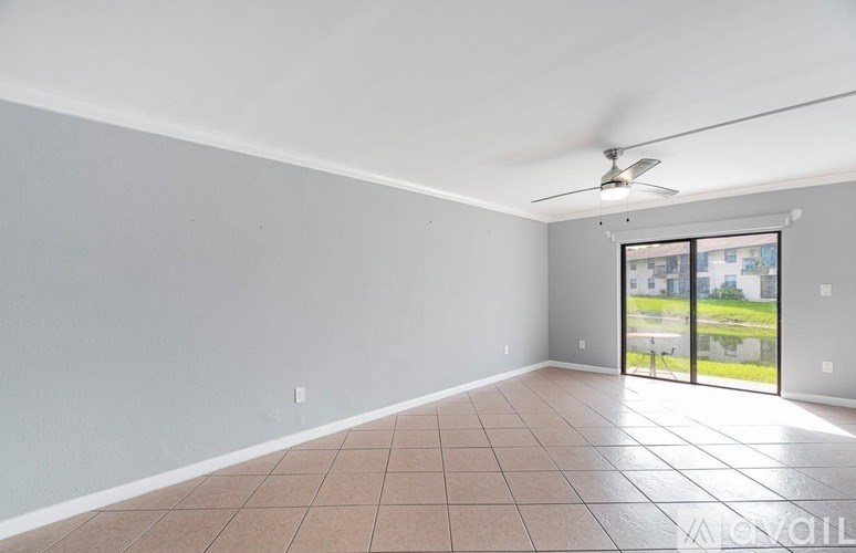A room with a sliding glass door leading to a balcony.