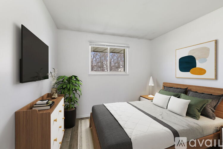 A bedroom with a bed, nightstand, and a television.