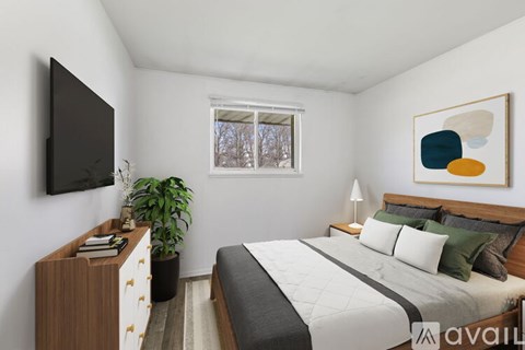A bedroom with a bed, nightstand, and a television.