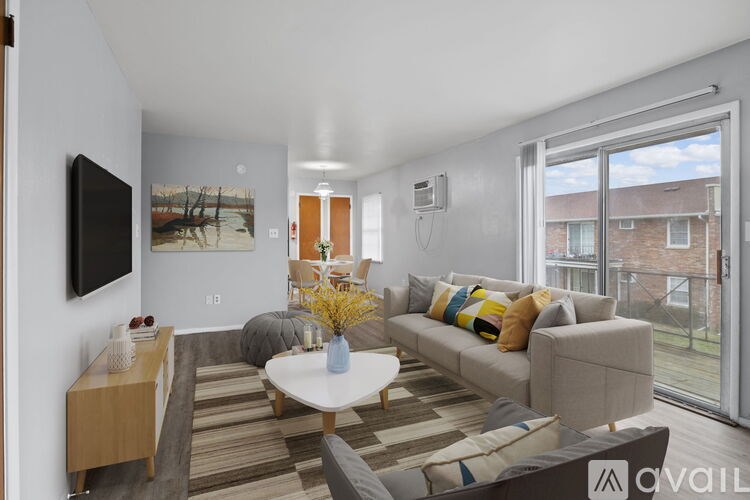 A living room with a sofa, a coffee table, and a television.