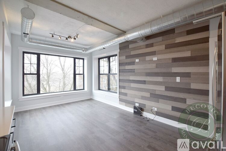 A room with a wall made of wooden planks and a window.