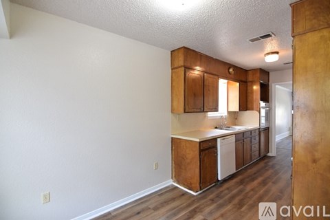 A kitchen with wooden cabinets and a white countertop.
