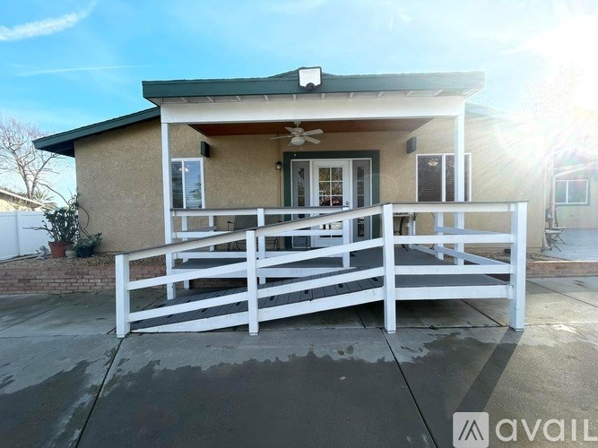 A house with a white fence in front of it.