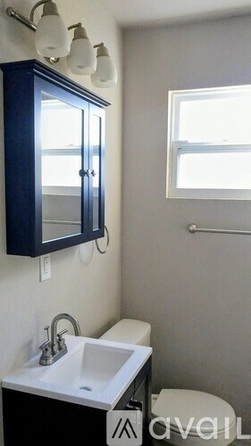 A room with a white door and a window with brown curtains.