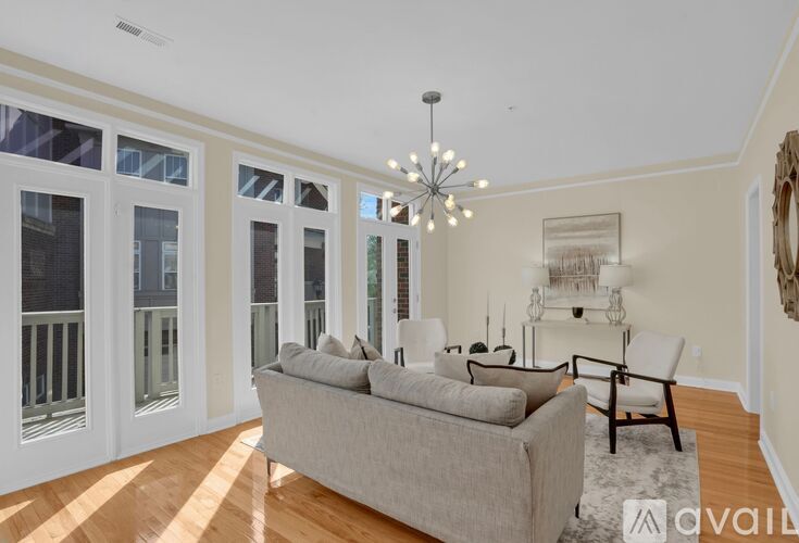 A room with wooden floors and a chandelier.