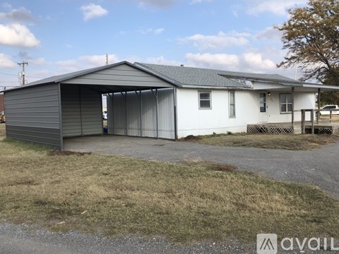 A house with a grey roof and a white exterior is available for rent.