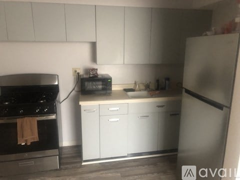 A kitchen with white cabinets and a black stove top.