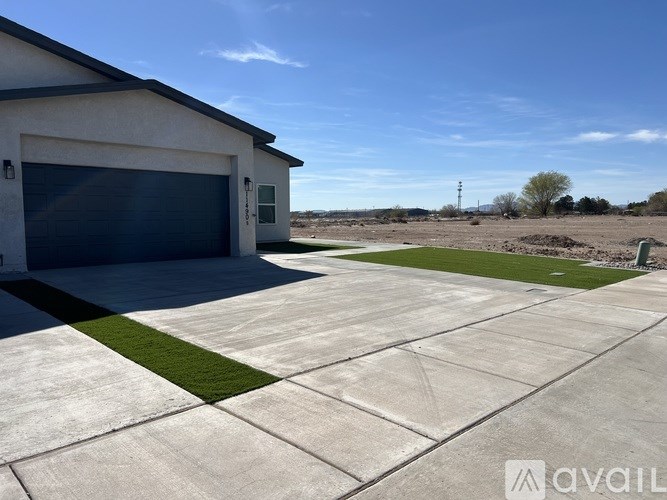 A house with a garage and a driveway in front.