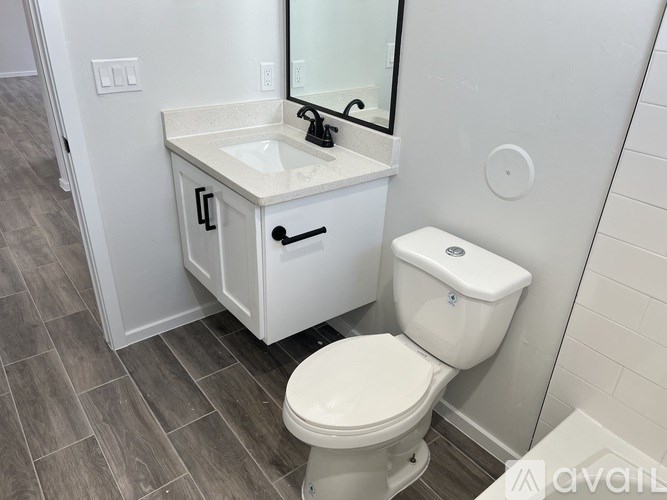 A white sink and toilet in a bathroom.