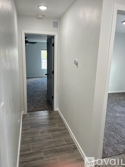 A hallway with a door at the end.