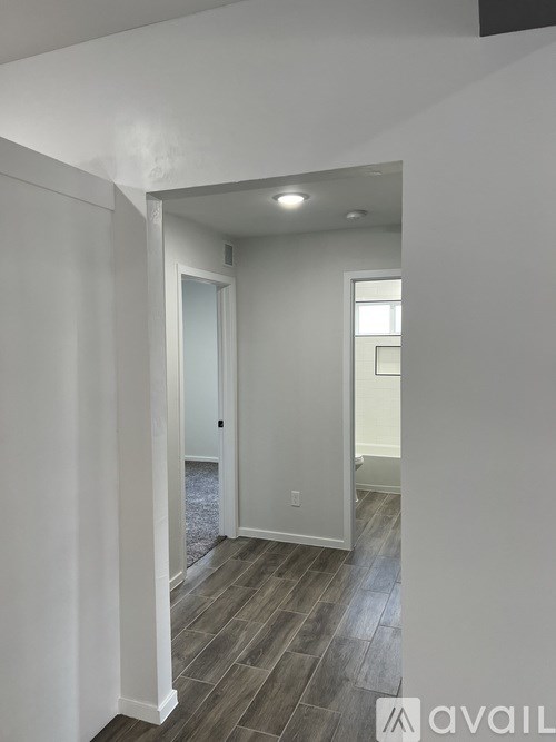 A hallway with a door and a window.