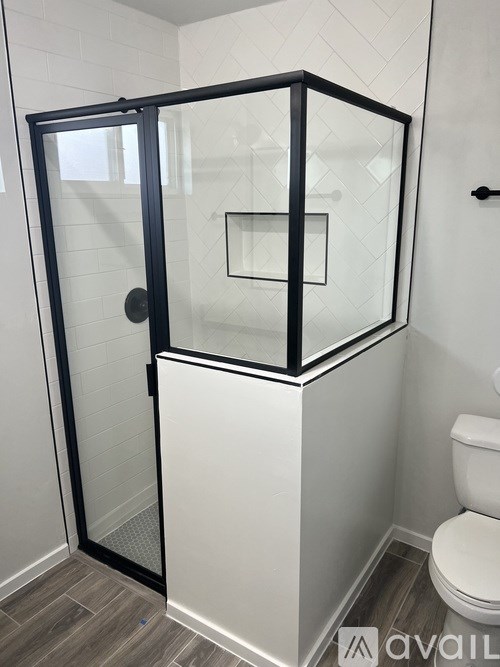 A white bathroom with a glass shower stall.