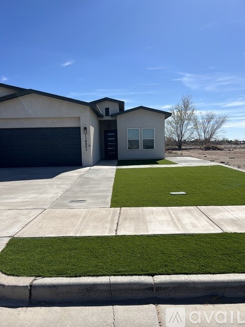 A house with a garage and a driveway in front.