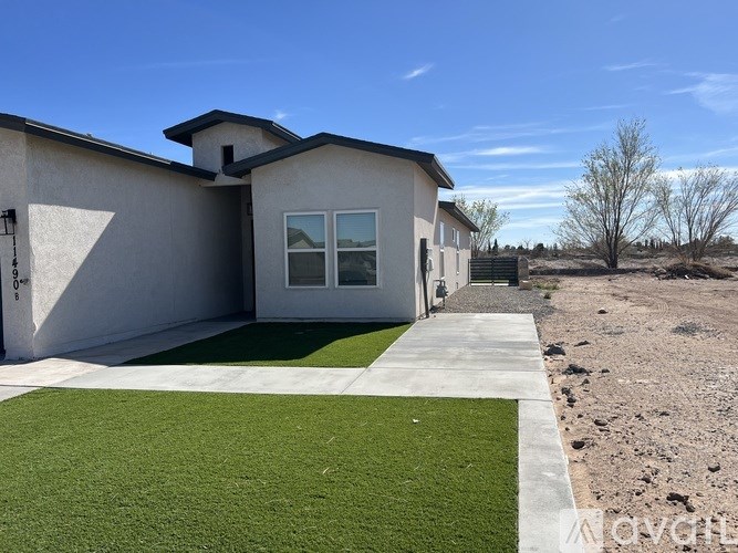 A house with a green lawn in front.