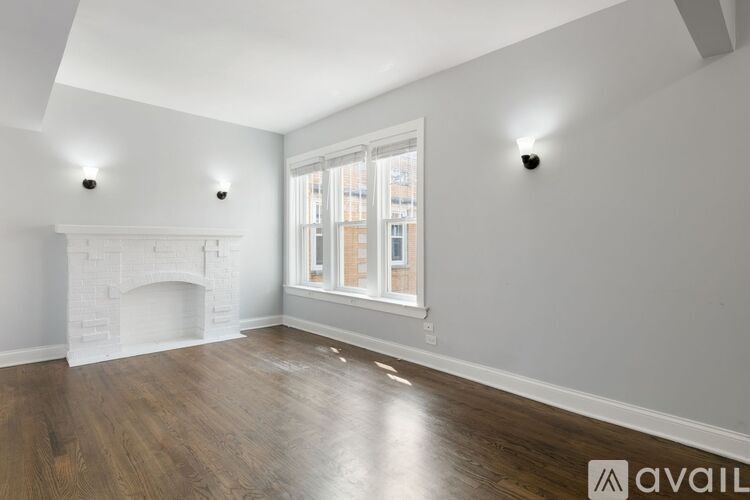 A room with a fireplace and a window.
