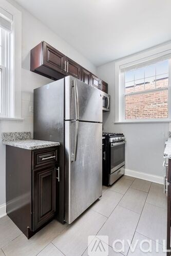 A kitchen with a stainless steel refrigerator and oven.