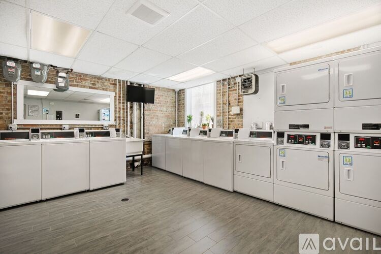 A control room with white cabinets and a brick wall.