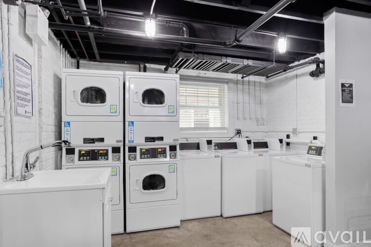 A row of industrial washing machines are available for purchase.