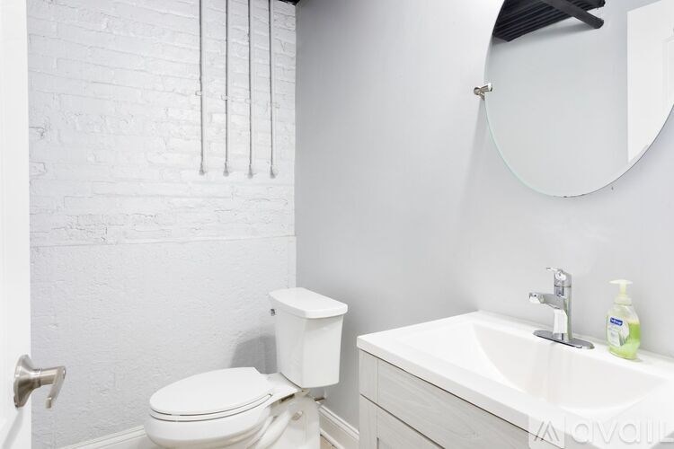 A white toilet and sink in a bathroom.