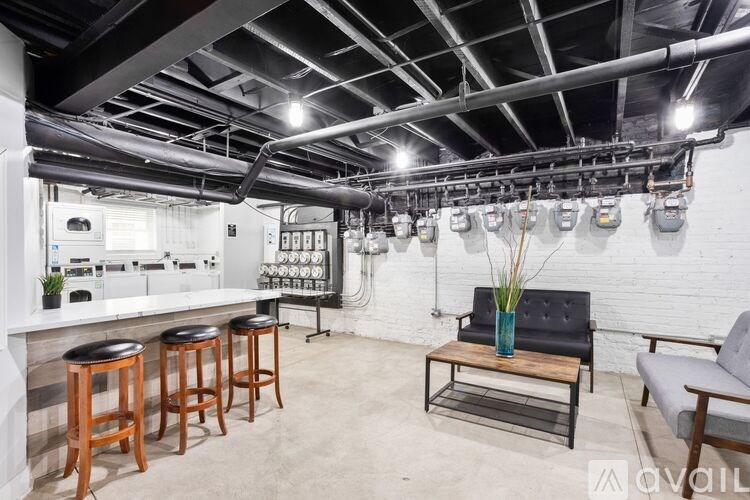 A modern kitchen with a bar area and a dining table.