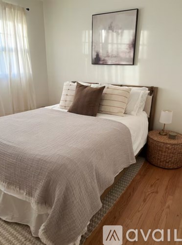 A white bathroom with a white tub and a white shower curtain.