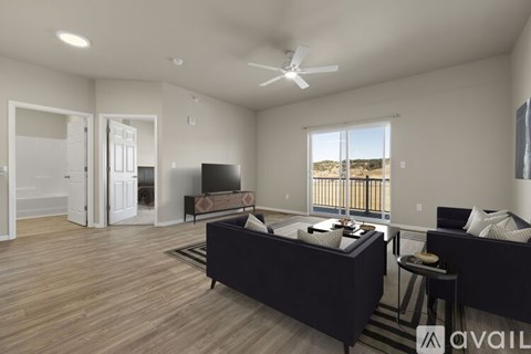 A spacious living room with a large couch and a television.