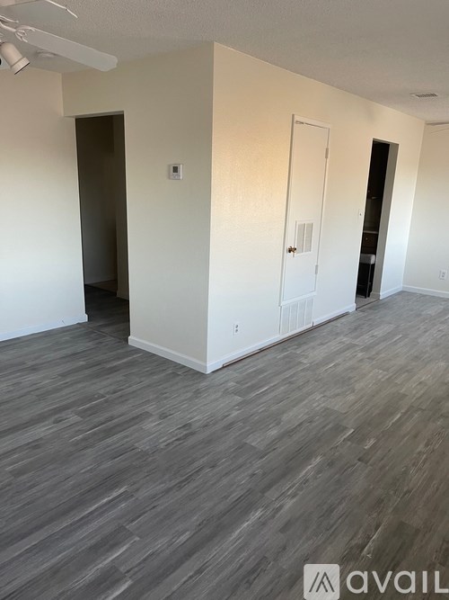 A room with grey flooring and white walls.
