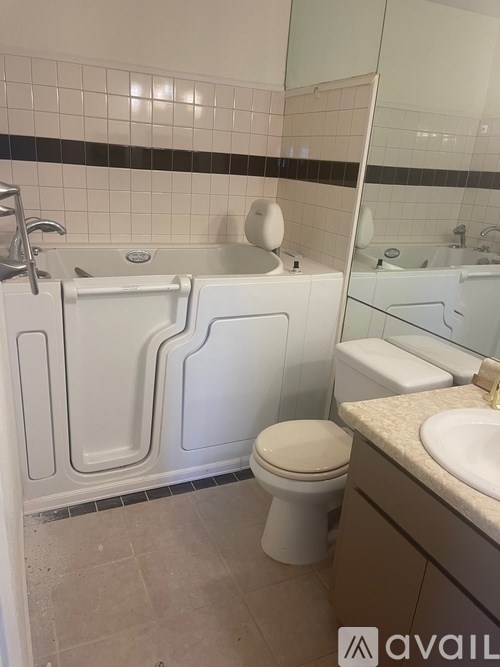 A bathroom with a white toilet, sink, and bathtub.