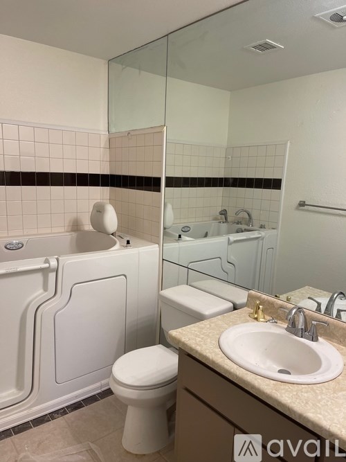 A bathroom with a toilet, sink, and bathtub.