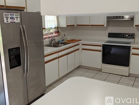 A kitchen with a stainless steel refrigerator and an oven.