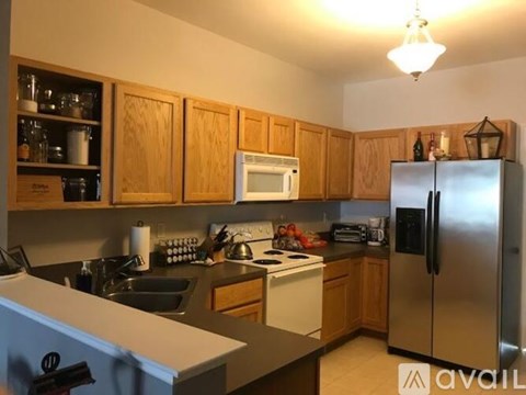 A kitchen with wooden cabinets and stainless steel appliances.
