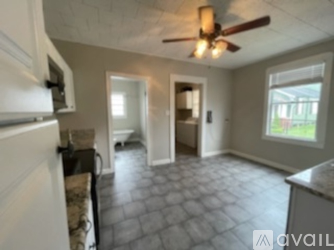 A kitchen with a fan and a window.