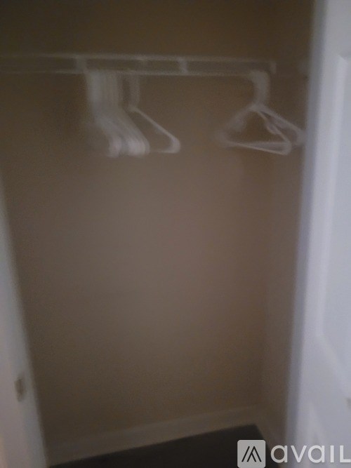 Three hangers are hanging on a wire.