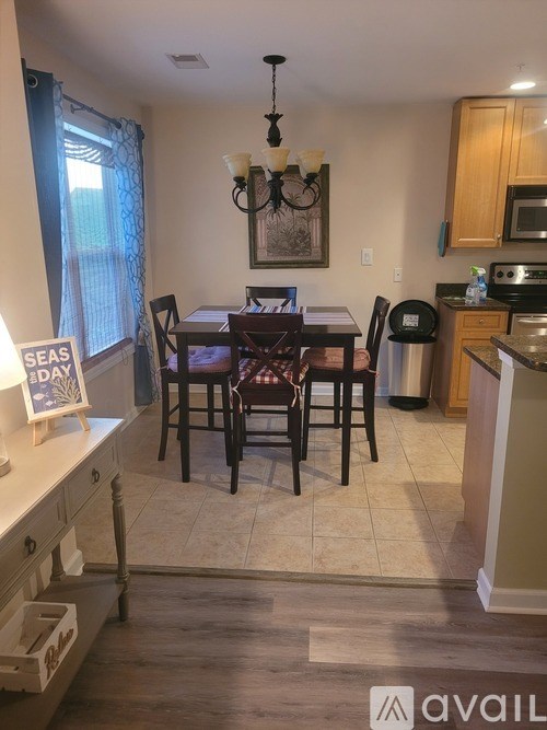 A kitchen with a dining table and chairs.
