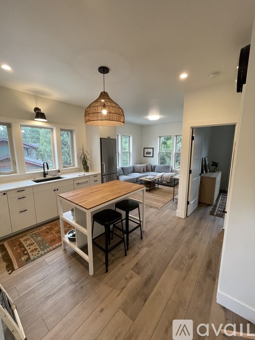 A kitchen with a table and chairs in the middle of the room.
