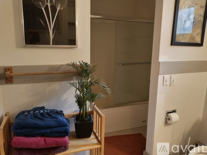 A towel rack with three towels hanging on it.