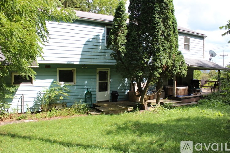 A room with a ladder, bookshelf, and a painting on the wall.