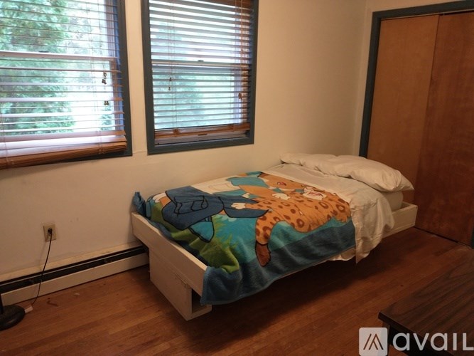 A house with a blue exterior and a white garage door.