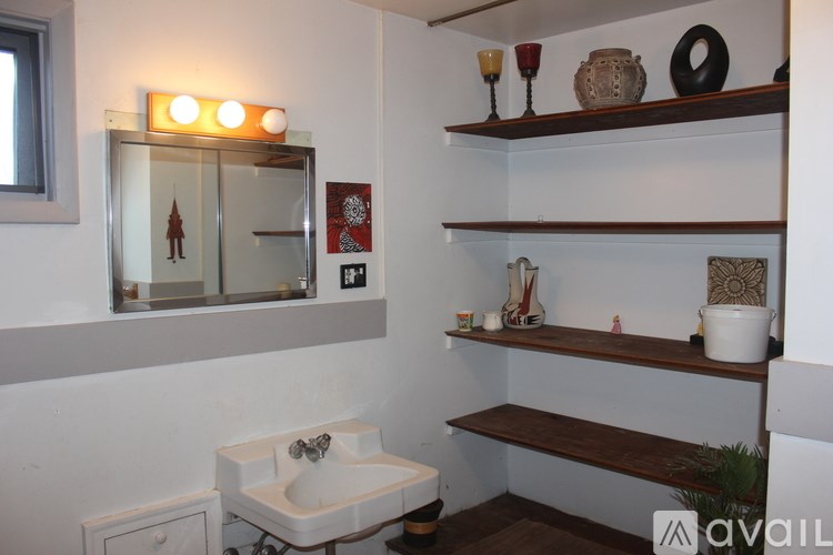 A kitchen with a white refrigerator and wooden cabinets.