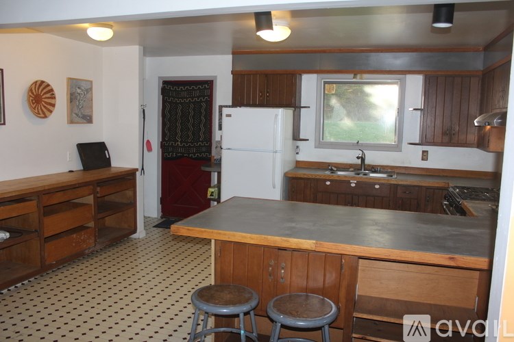A house with a blue exterior and a white garage door.
