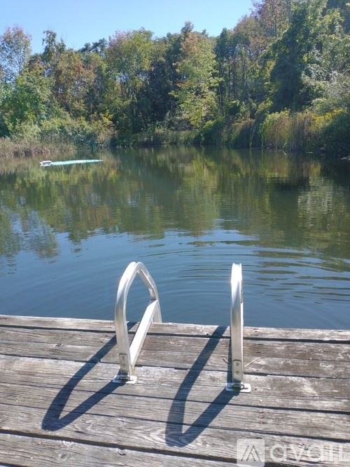 A dock with metal poles sticking out of the water.