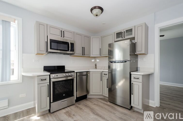 A kitchen with a stove top oven, microwave, and refrigerator.