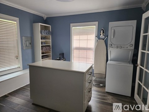 A kitchen with a white counter and a white fridge.