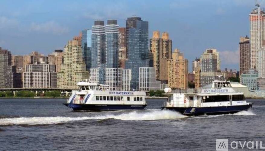 A boat with the words "Bayonne" on it is in the foreground of a city skyline.