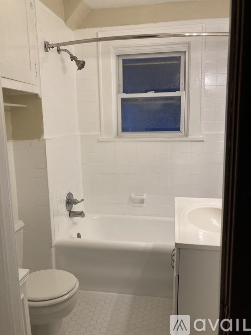 A white toilet is next to a bathtub in a bathroom.