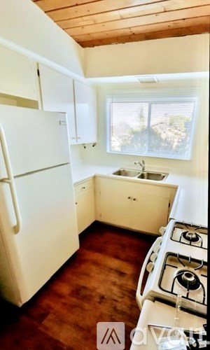 A room with wooden floors and a sliding glass door.