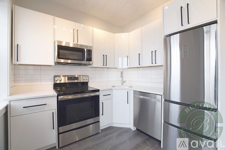 A kitchen with white cabinets and stainless steel appliances.