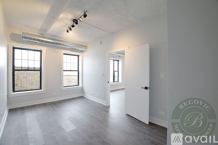 A spacious room with a window and a door.