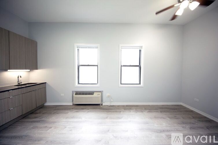 A spacious room with a window, a counter, and a floor heater.