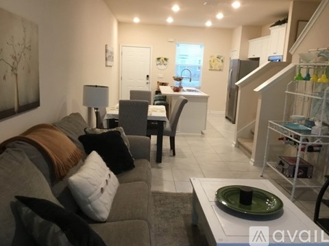 A living room with a grey couch and a white coffee table.
